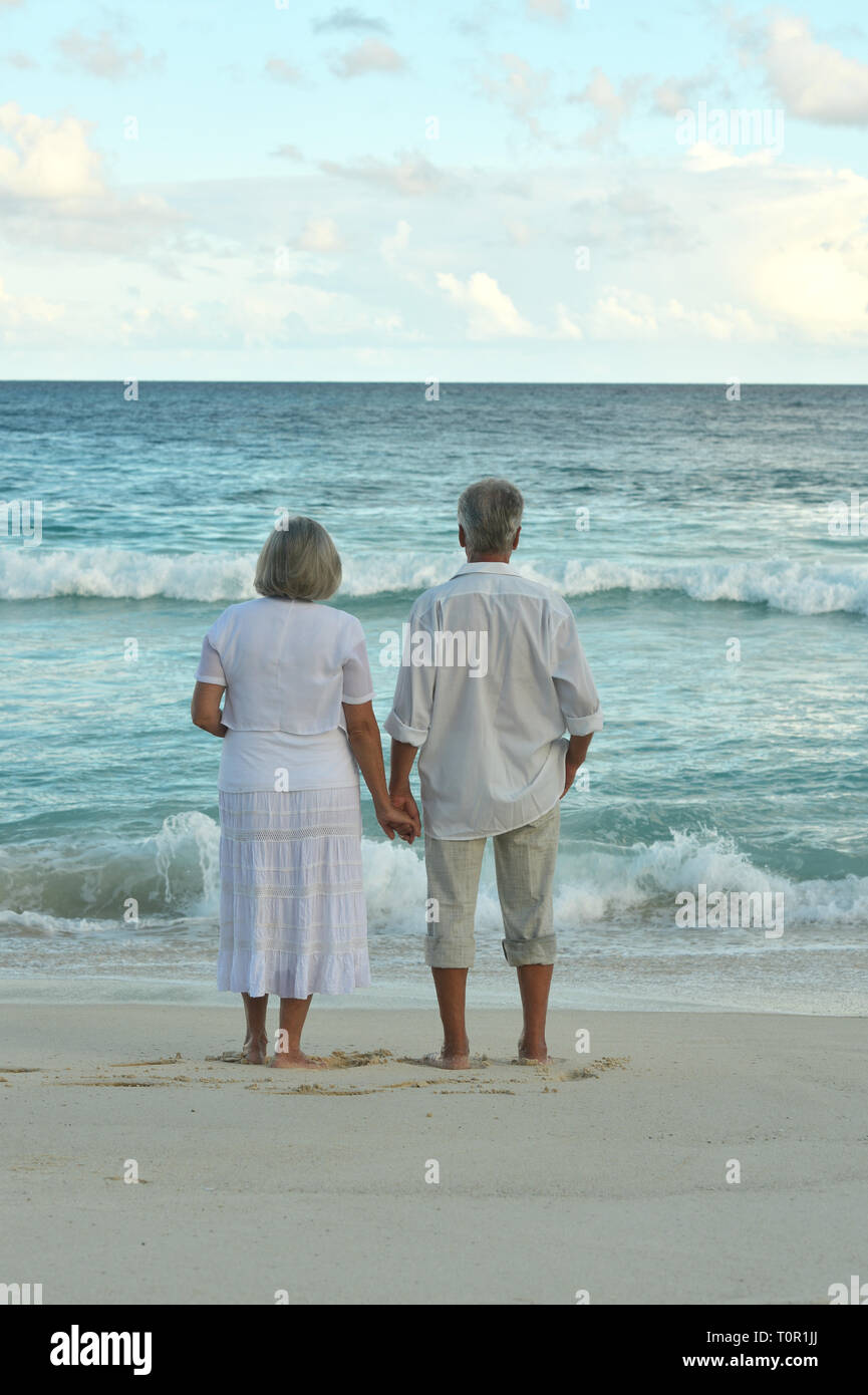 Portrait of elderly couple resting on tropical beach Stock Photo - Alamy