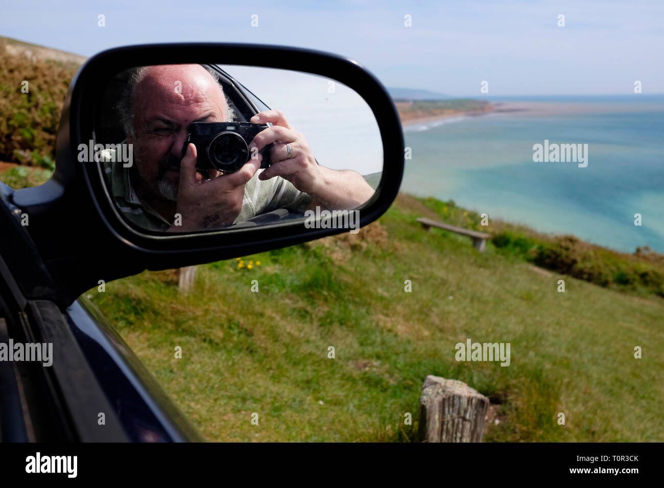 photographer,taking,picture,of,Compton Bay,reflected,in,car,side,mirror,Isle of Wight,England,UK, Stock Photo