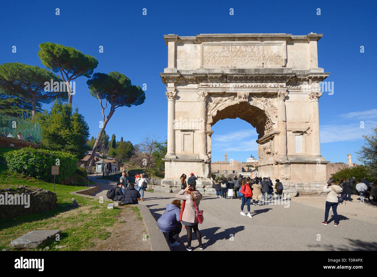 Tourists Around the Triumphal Arch of Titus cAD82 on the Via Sacra Roman Road, Roman Forum, Rome Italy. Celebrates Victory of Rome over Jerusalem 70AD Stock Photo