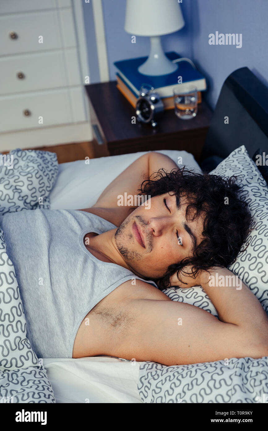 Man sleeping in bed at home Stock Photo