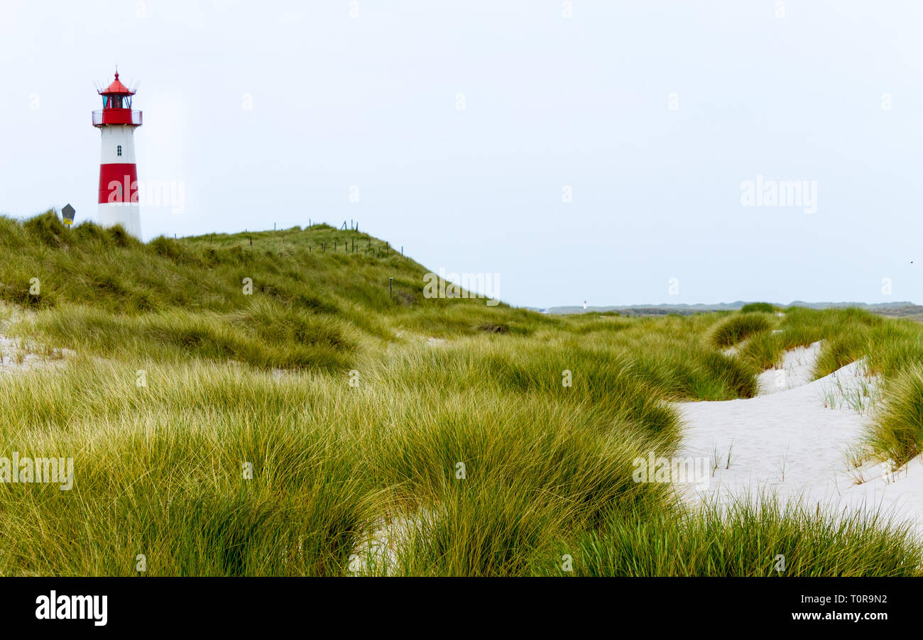 Lighthouse List-Ost inside a Dune Landscape with grass and sand. Detail view on a clear day. Located in List auf Sylt, Schleswig-Holstein, Germany. Stock Photo