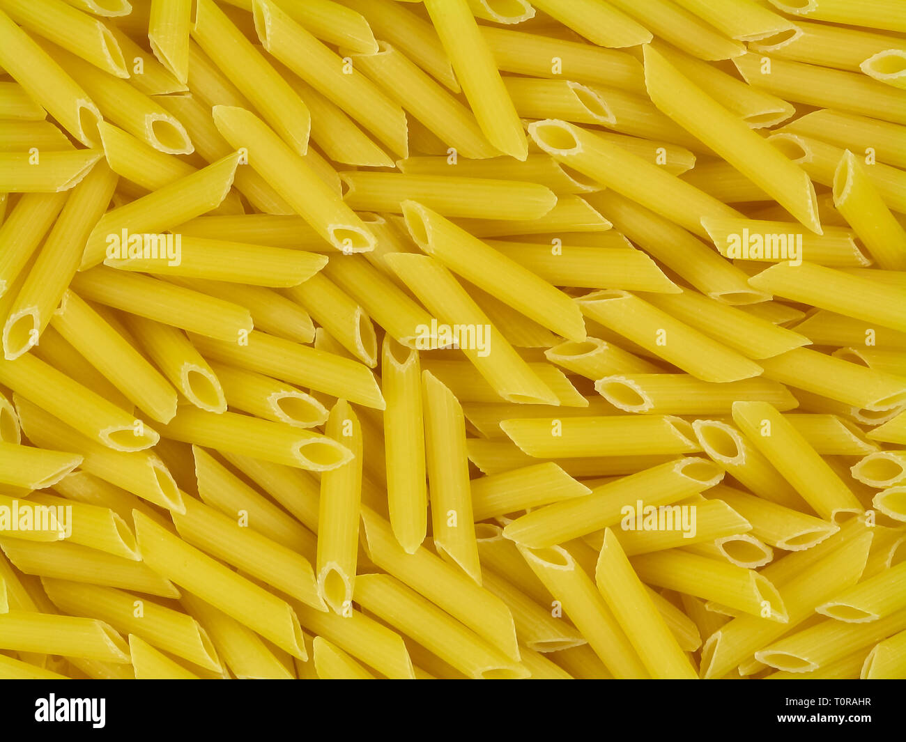 Download Uncooked Yellow Italian Pasta Penne Doppia Rigatura Texture Top View Close Up Stock Photo Alamy Yellowimages Mockups