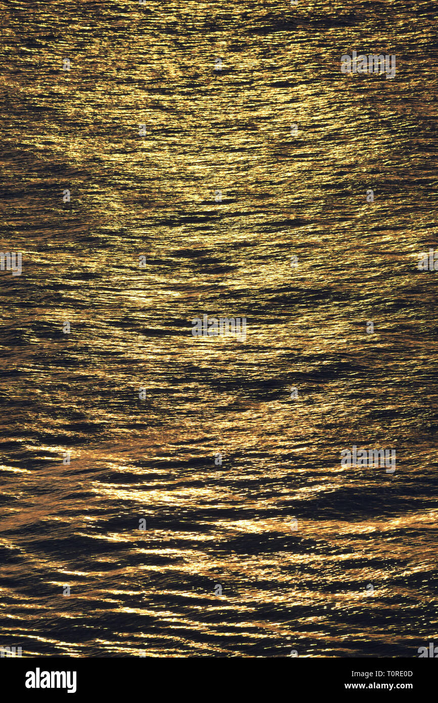 Golden sun reflecting on sea Stock Photo - Alamy