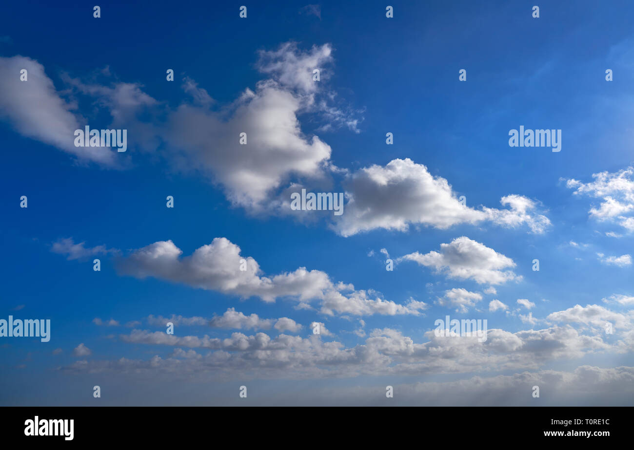 Blue summer sky with white clouds background Stock Photo - Alamy