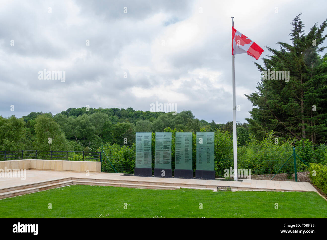 Four glass steles with the names of the fallen under the Canadian flag, Canadian Memorial Garden, Mémorial de Caen (Caen Memorial), Normandy, France. Stock Photo
