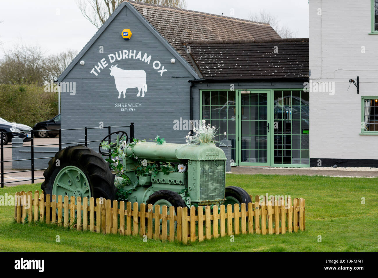 A vintage Fordson tractor displayed outside the Durham Ox pub, Shrewley, Warwickshire, England, UK Stock Photo