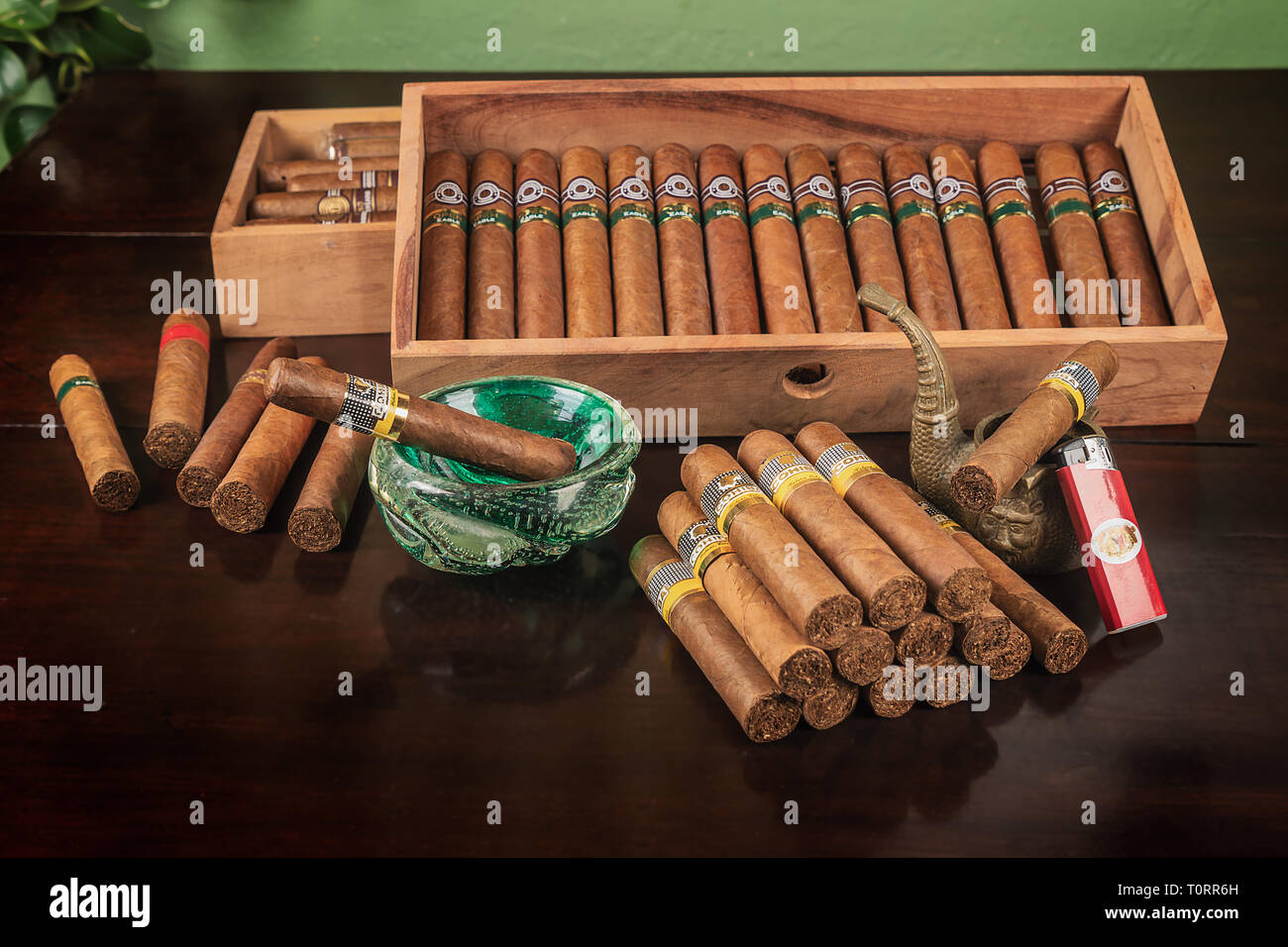 A goup of cohiba cuban cigars, two ashtray a lighter an to box of