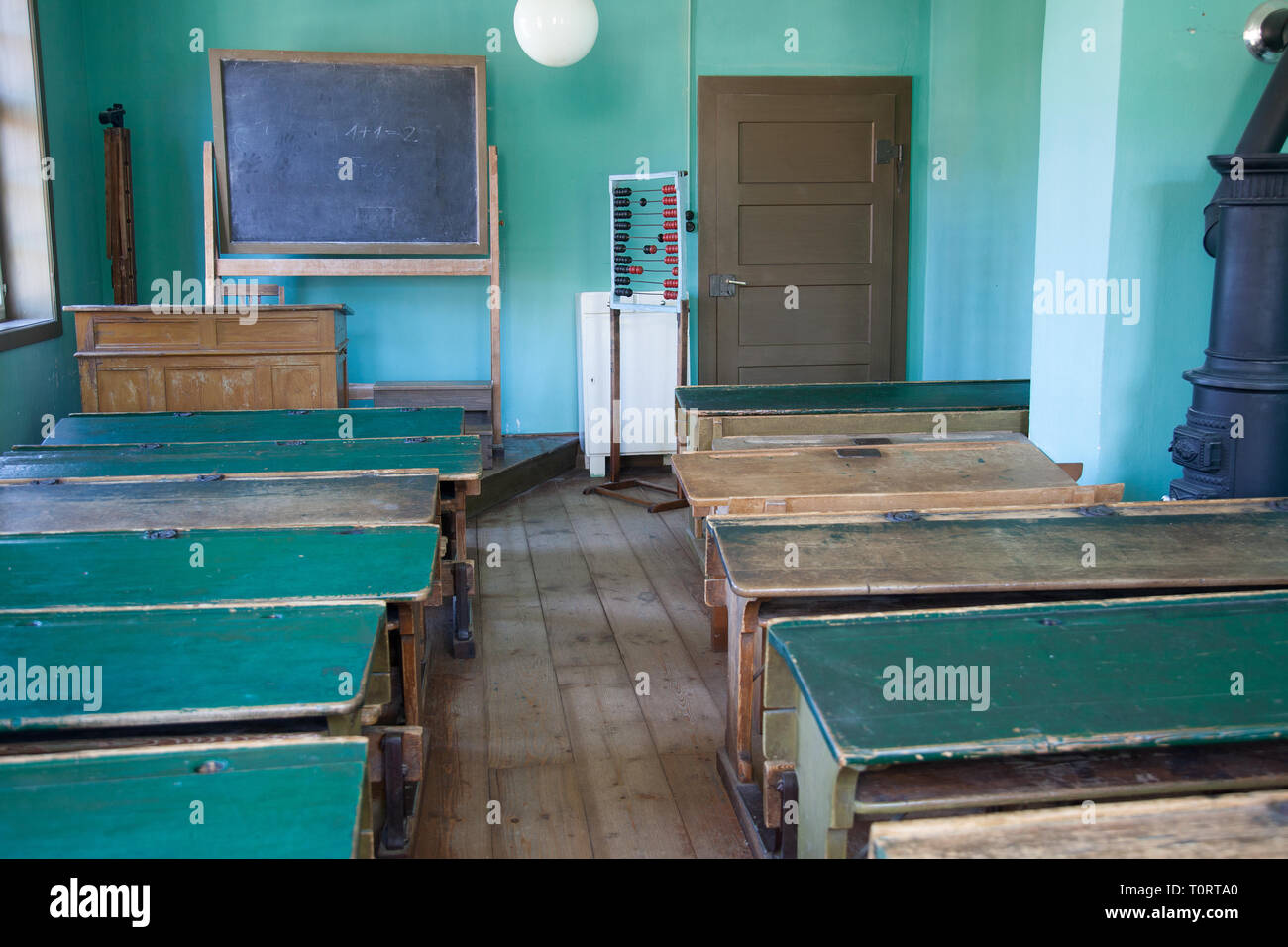 Antique classroom with empty wooden desks and benches Stock Photo Alamy