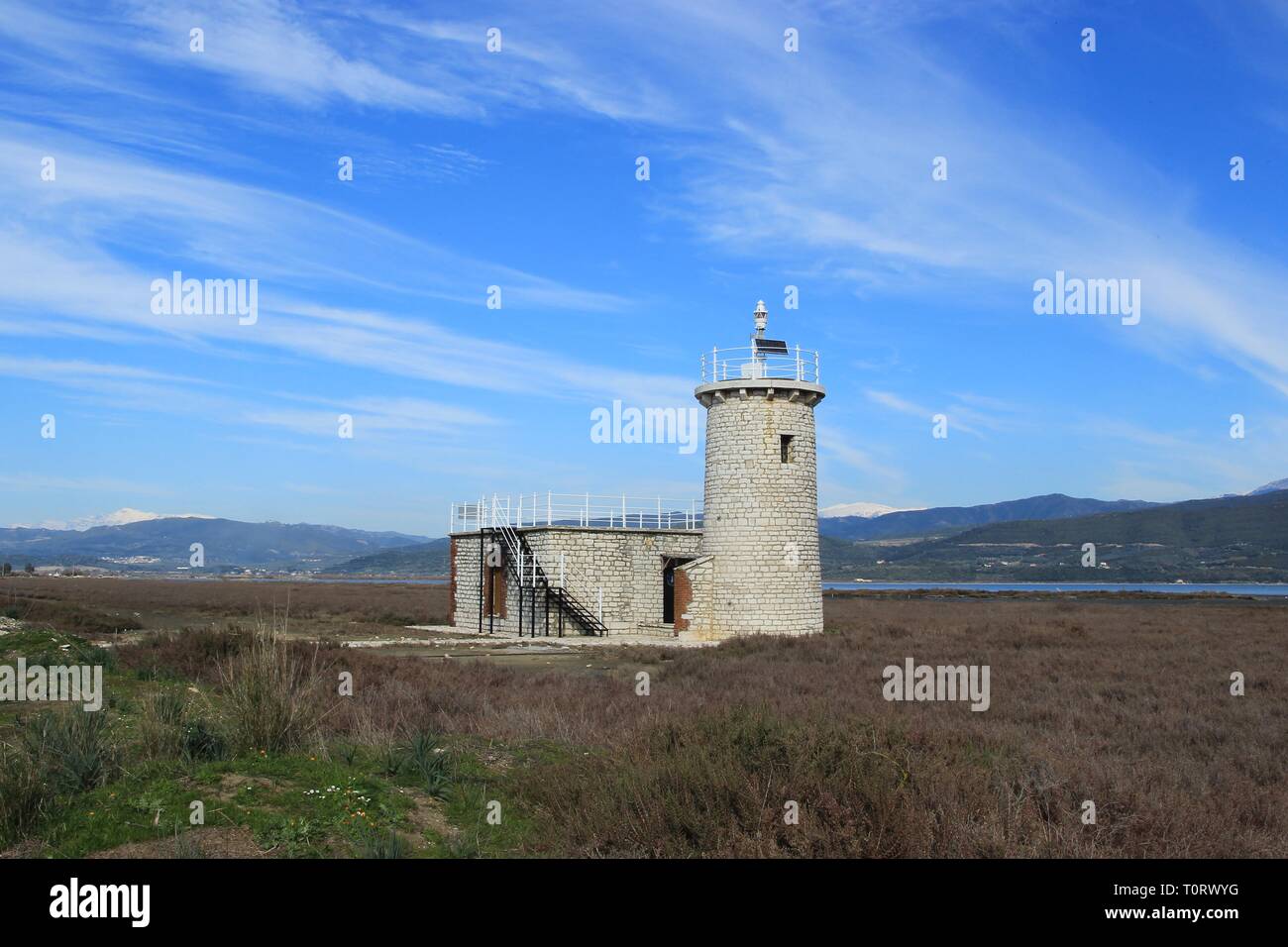 Old stone lighthouse tower and beacon at the Ambracian (Amvrakikos) gulf wetland at Kopraina village in Arta region in Epirus Greece at winter Stock Photo