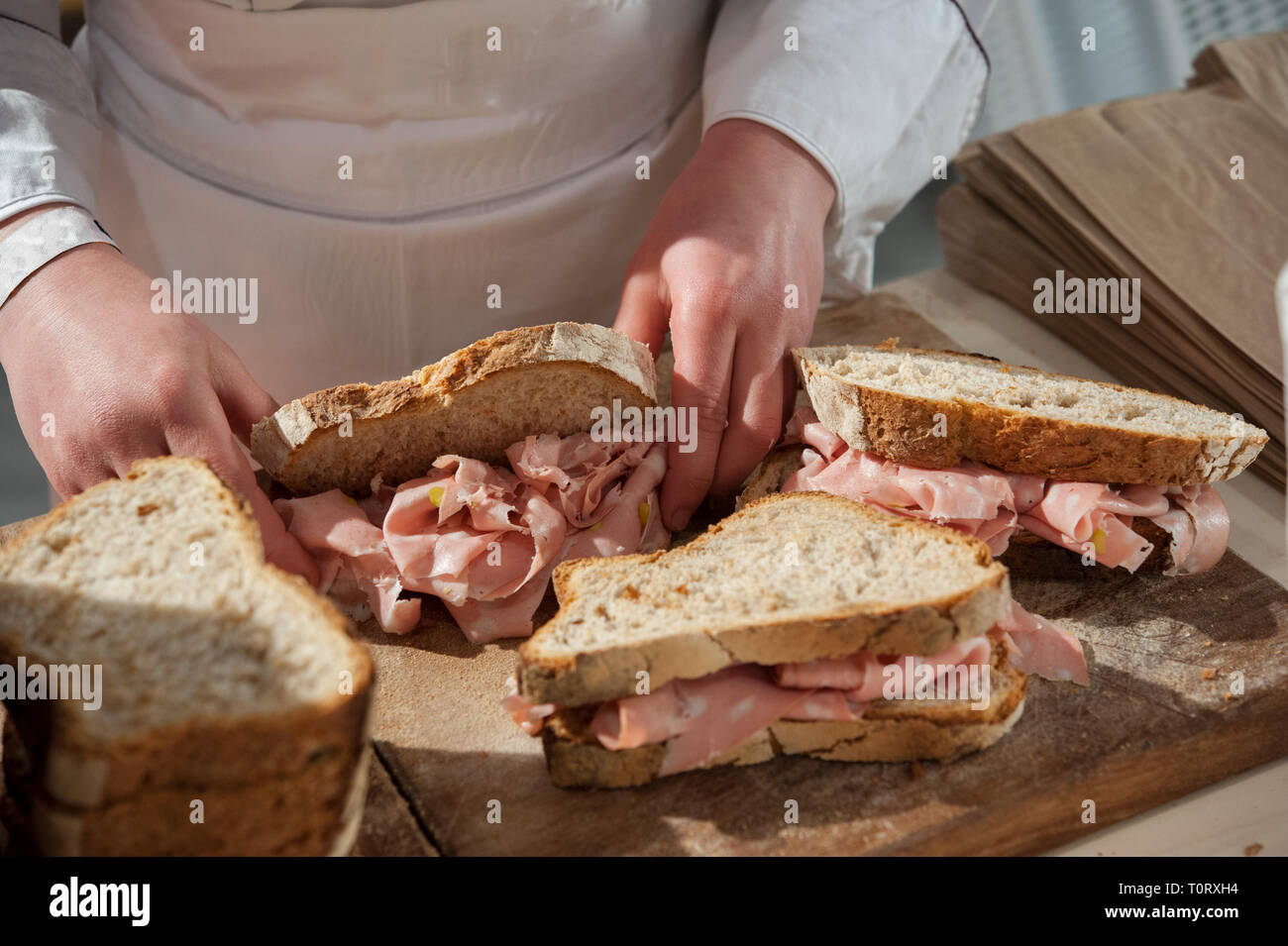 Preparing appetizing Mortadella Bologna sandwiches. Close up. Stock Photo