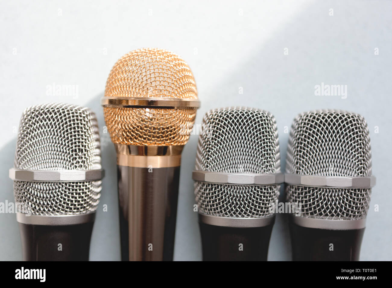 leadership concept. group of microphones with golden one. freedom to speak up concept. Stock Photo