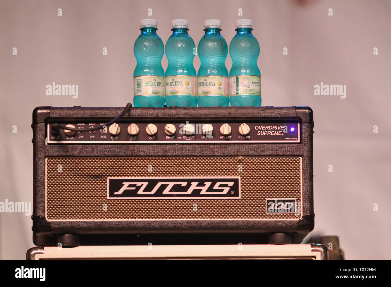 A line up of beverages on amp are shown during a 'live' concert performance. Stock Photo