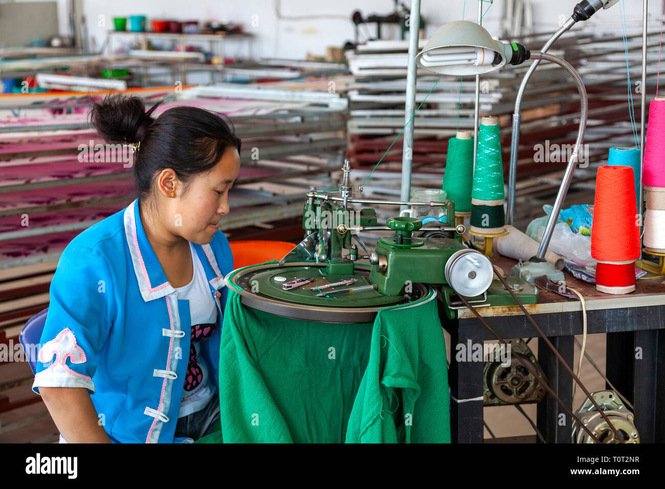 Handicraft worker with industrial sewing machine in Hohhot, capital of Inner Mongolia, China. Stock Photo