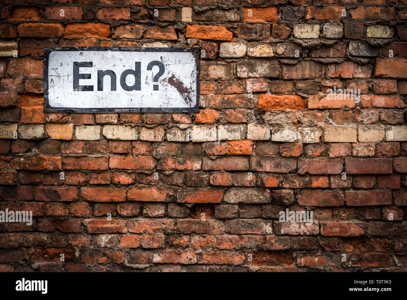 Uncertainty Concept Image Of A Grungy Sign Saying End? On An Old Red Brick Wall Stock Photo