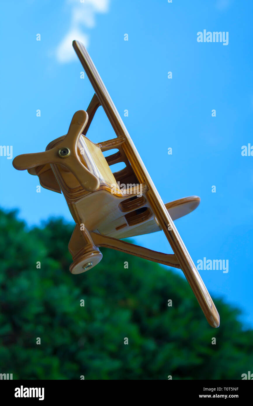 toy plane flying over mountain Stock Photo