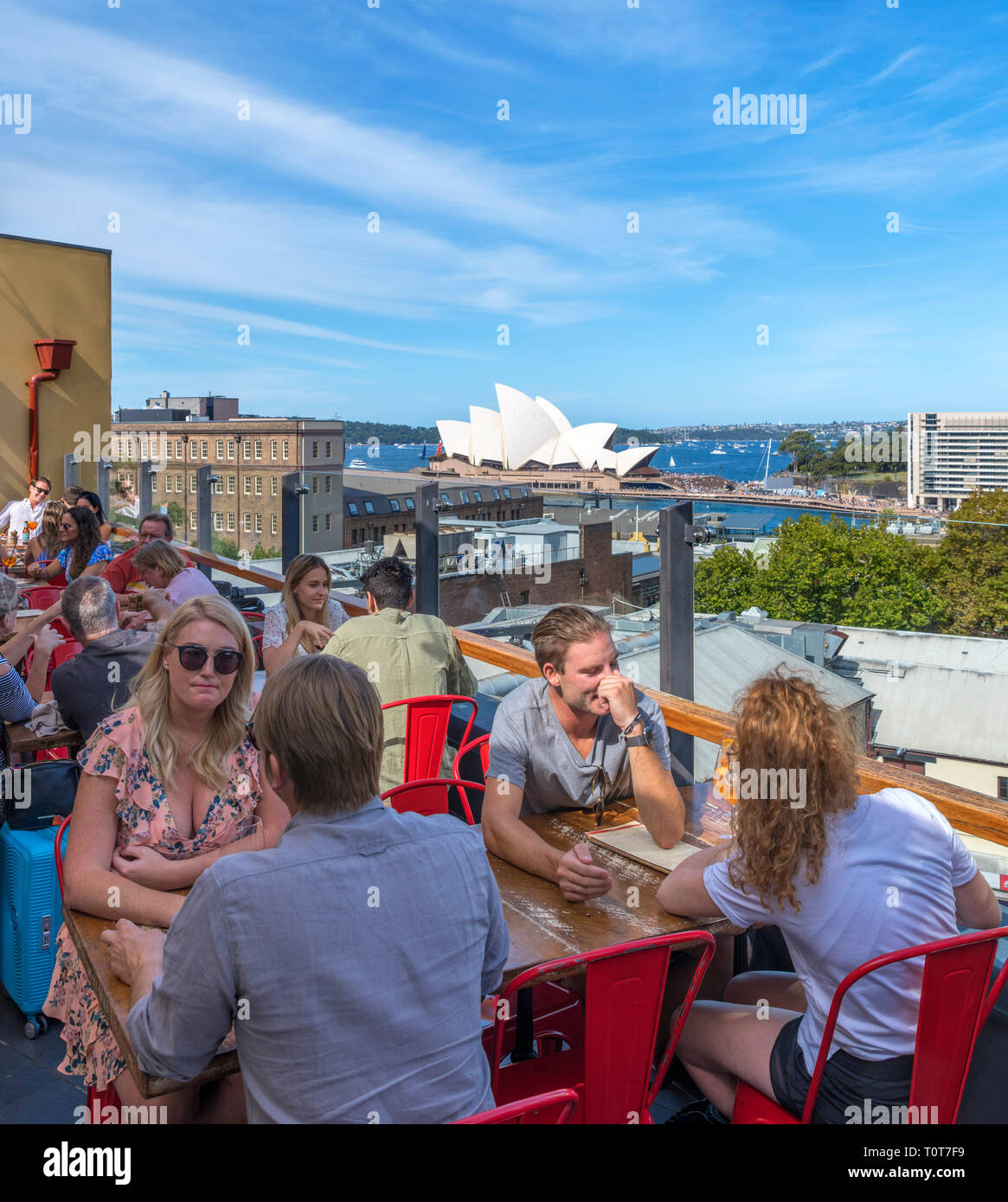Rooftop bar of the Glenmore Hotel with the Sydney Opera House in the distance, The Rocks, Sydney, Australia Stock Photo