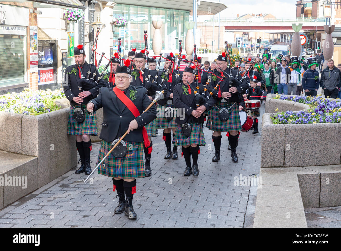 The annual St Patrick’s Day Parade from The Irish Club in Orford Lane to ‘The River of Life’ in Bridge Street. A short service remembered the 25th ann Stock Photo