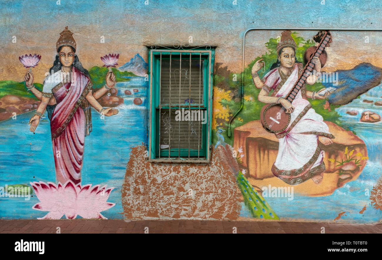 outdoor mural on wall at Annapurna restaurant: BrickLight District, Albuquerque, New Mexico [Hindu goddesses: Lakshmi (l.) Saraswati (r.)] Stock Photo