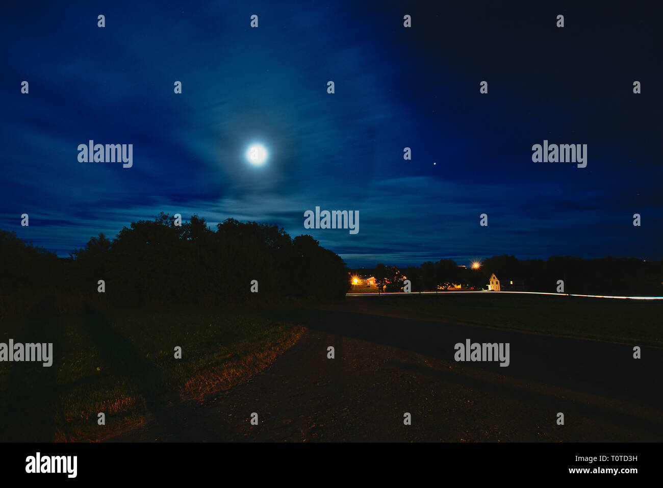 Moon and night sky overlooking farm house Stock Photo - Alamy