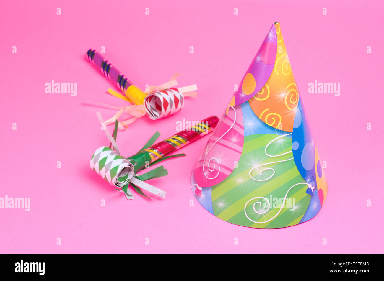 Party Hat and Blowing Whistle on Pink Background Stock Photo - Alamy
