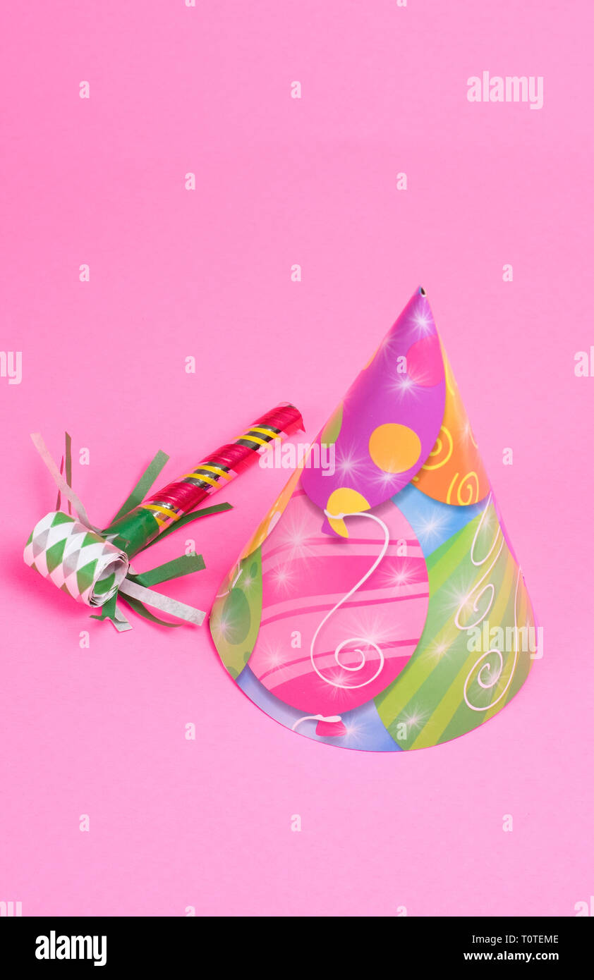 Party Hat and Blowing Whistle on Pink Background Stock Photo - Alamy