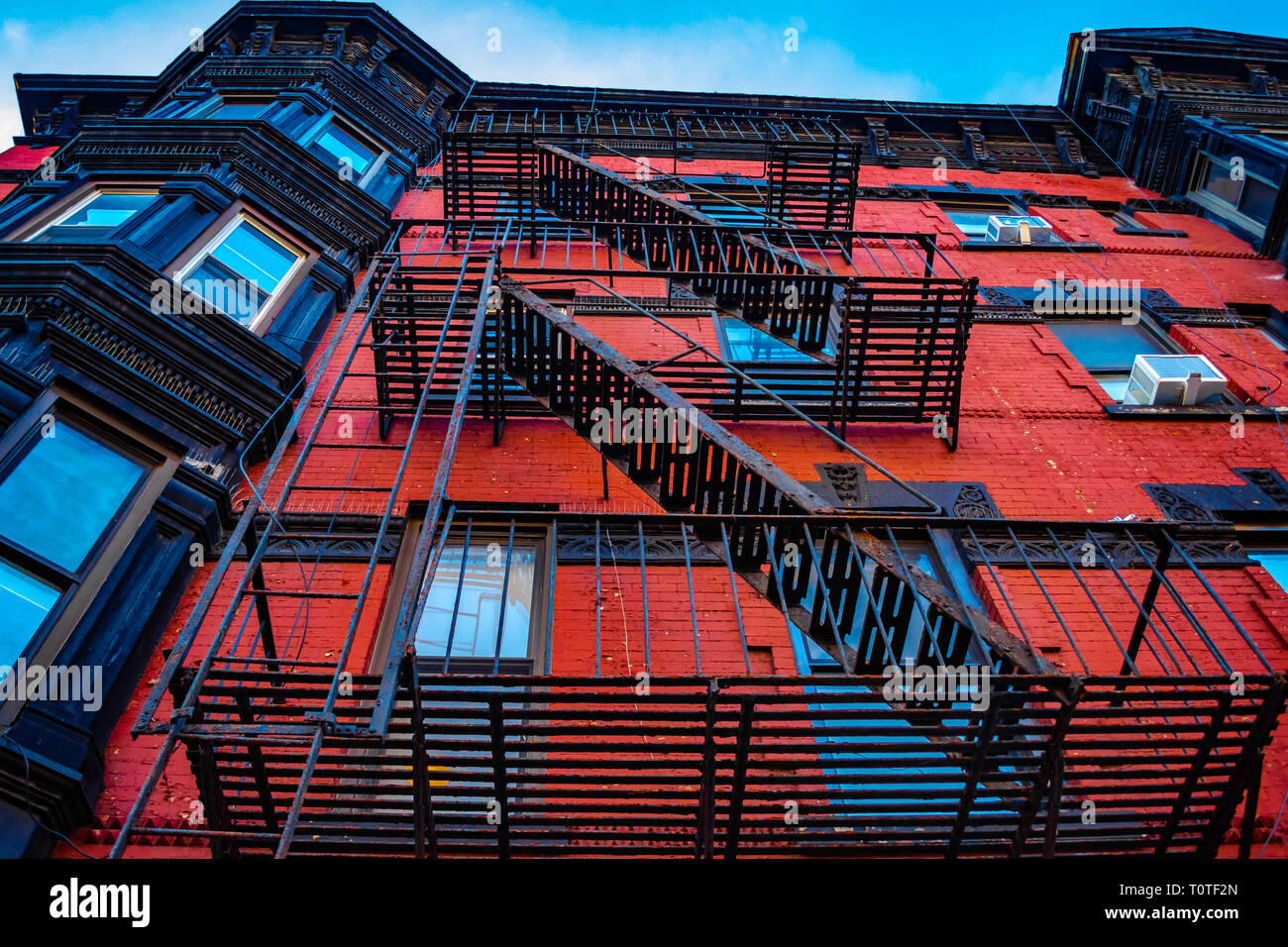 Beautiful red brick colonial apartment building fire escape in the Park Slope neighborhood in Brooklyn, New York, Spring 2019 Stock Photo