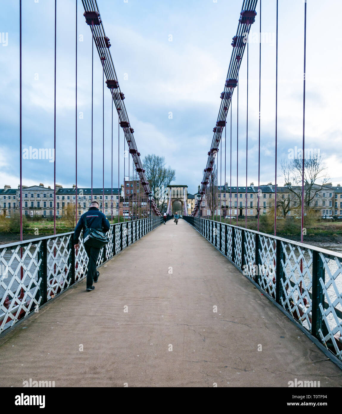 People walking across Portland Street suspension bridge, Glasgow, Scotland, UK Stock Photo