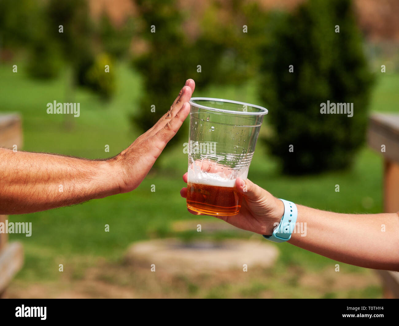 Stop alcohol concept. A man making a stop gesture to a glass of beer Stock Photo