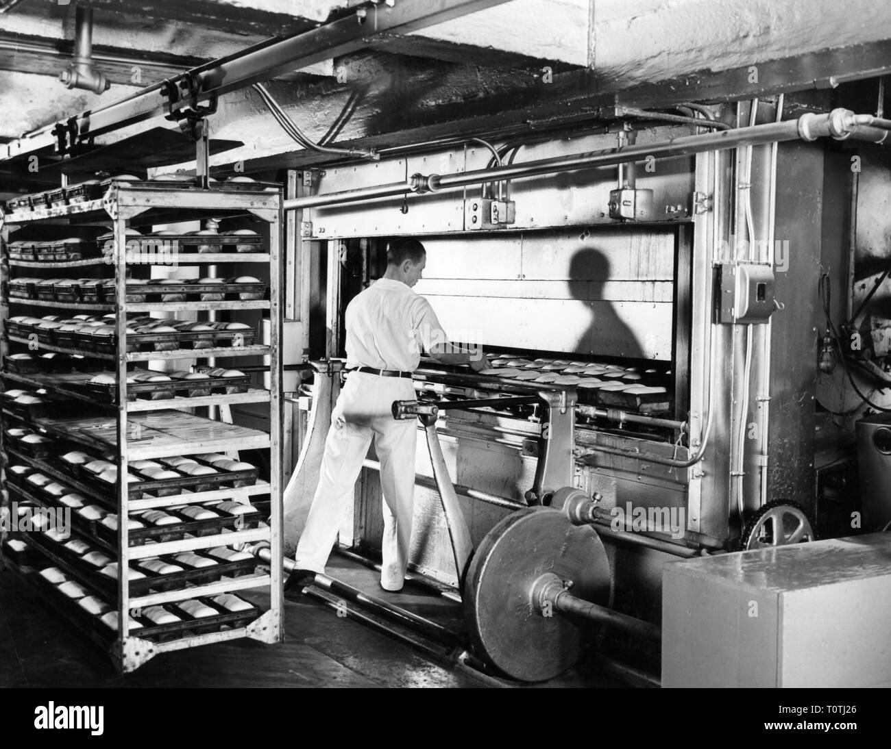 industry, food, bread, large bakery, worker at the baking oven, USA, 1950s, Additional-Rights-Clearance-Info-Not-Available Stock Photo
