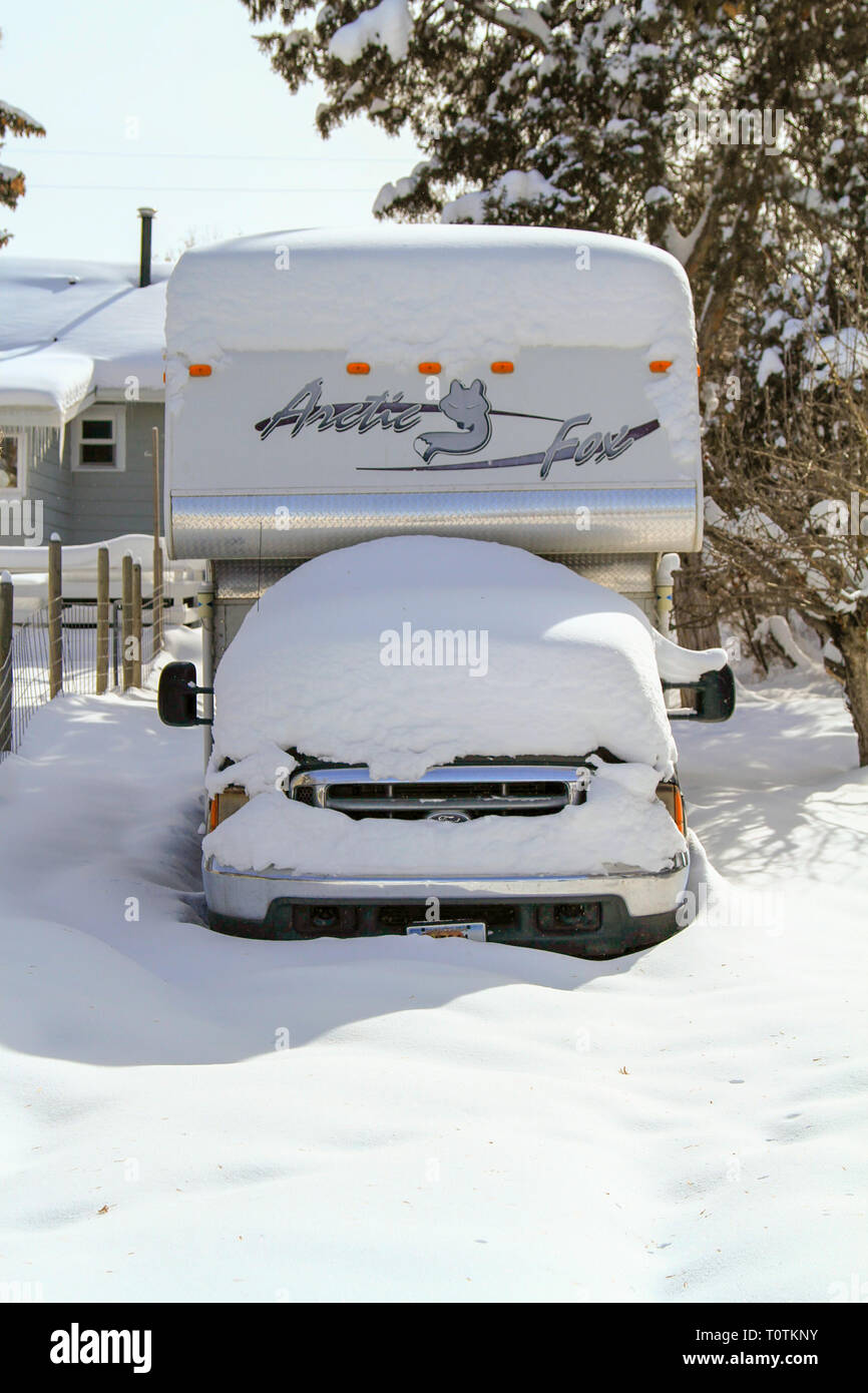 A snow covered Ford truck with an Arctic Fox slide in camper, Helena, Montana, USA Stock Photo