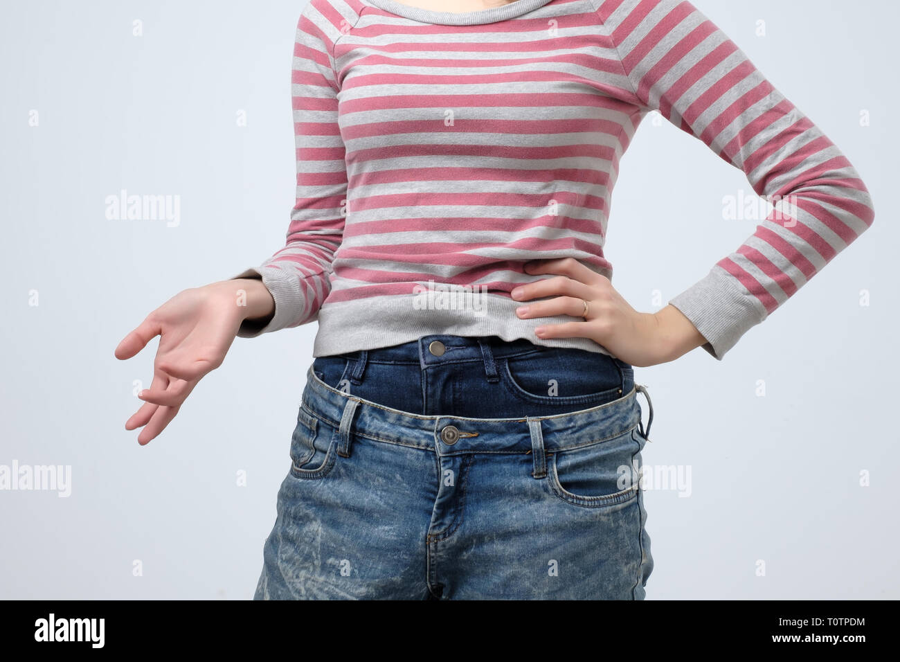 Woman wearing two jeans pants. Strange and odd fashion. She is very sloppy  Stock Photo - Alamy