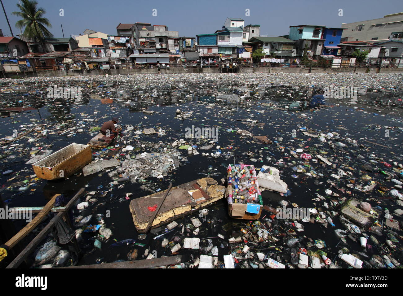A scavenger collects recyclable materials that can be sold to junkshops ...