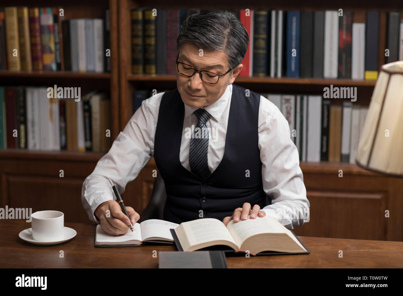 Serious senior writer reading hi-res stock photography and images - Alamy