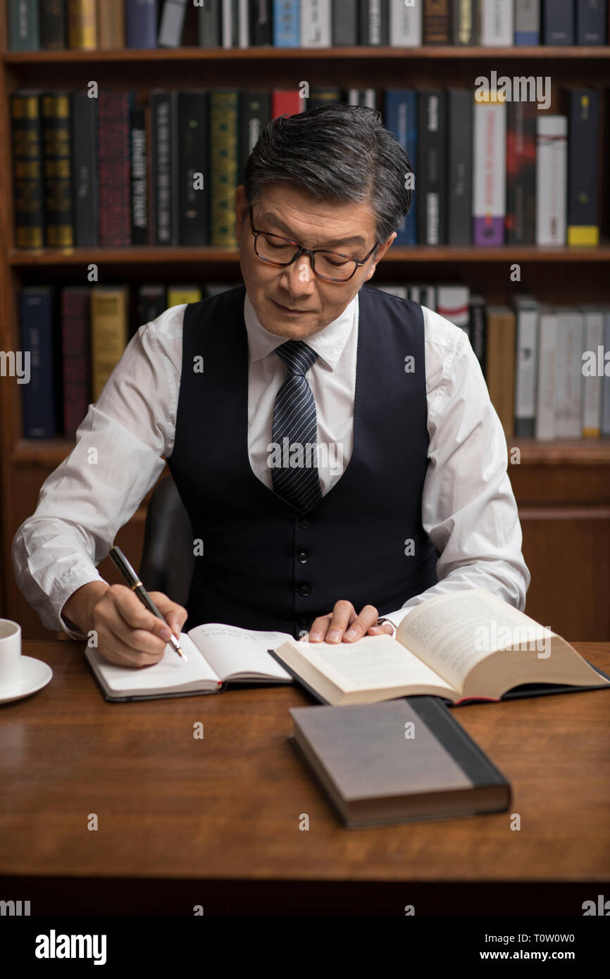 Serious senior writer reading hi-res stock photography and images - Alamy