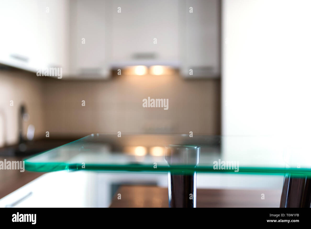 Blurred modern kitchen background with glass stand. With copy space for your design. Stock Photo