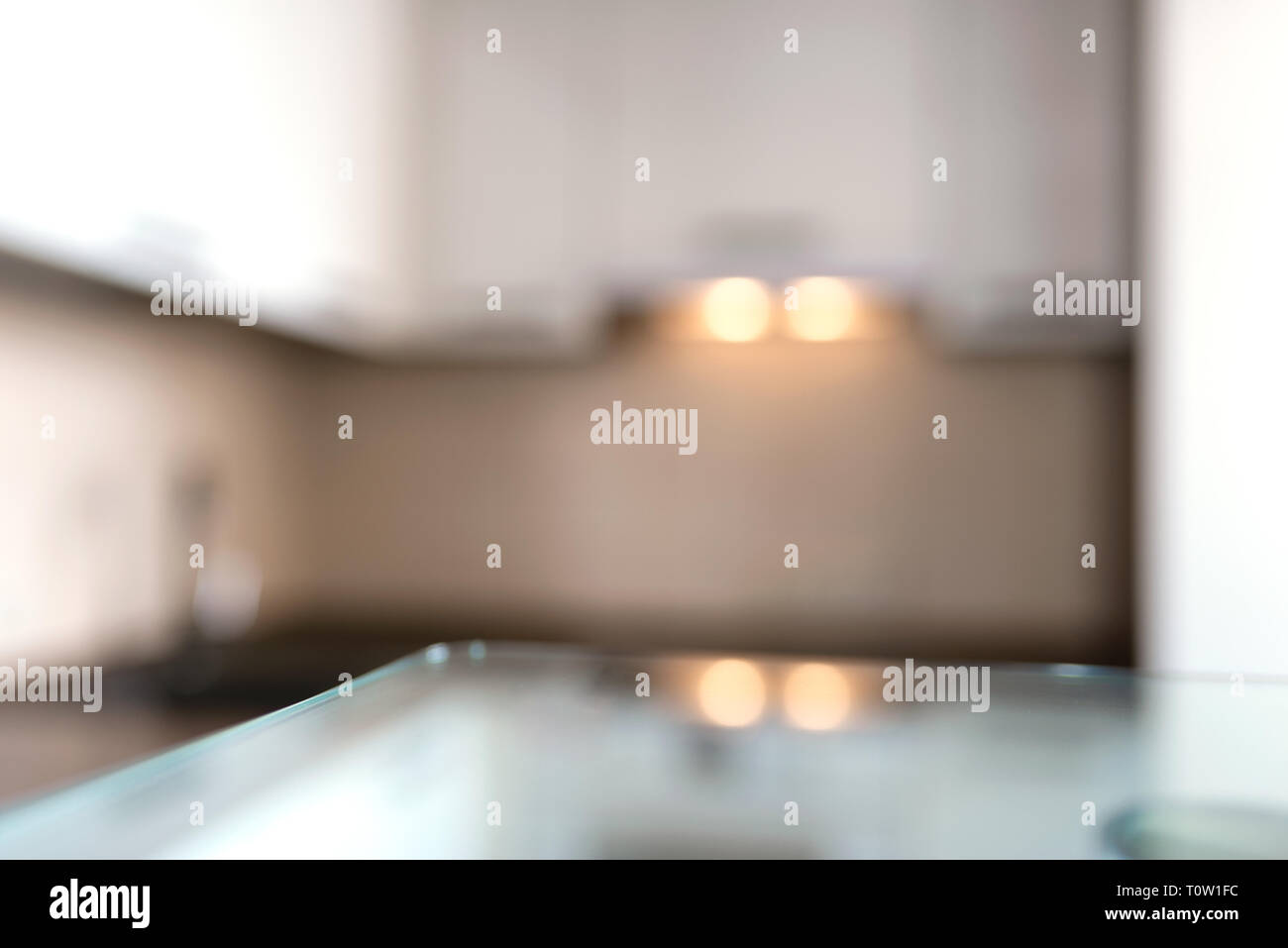 Blurred modern kitchen background with glass stand. With copy space for your design. Stock Photo