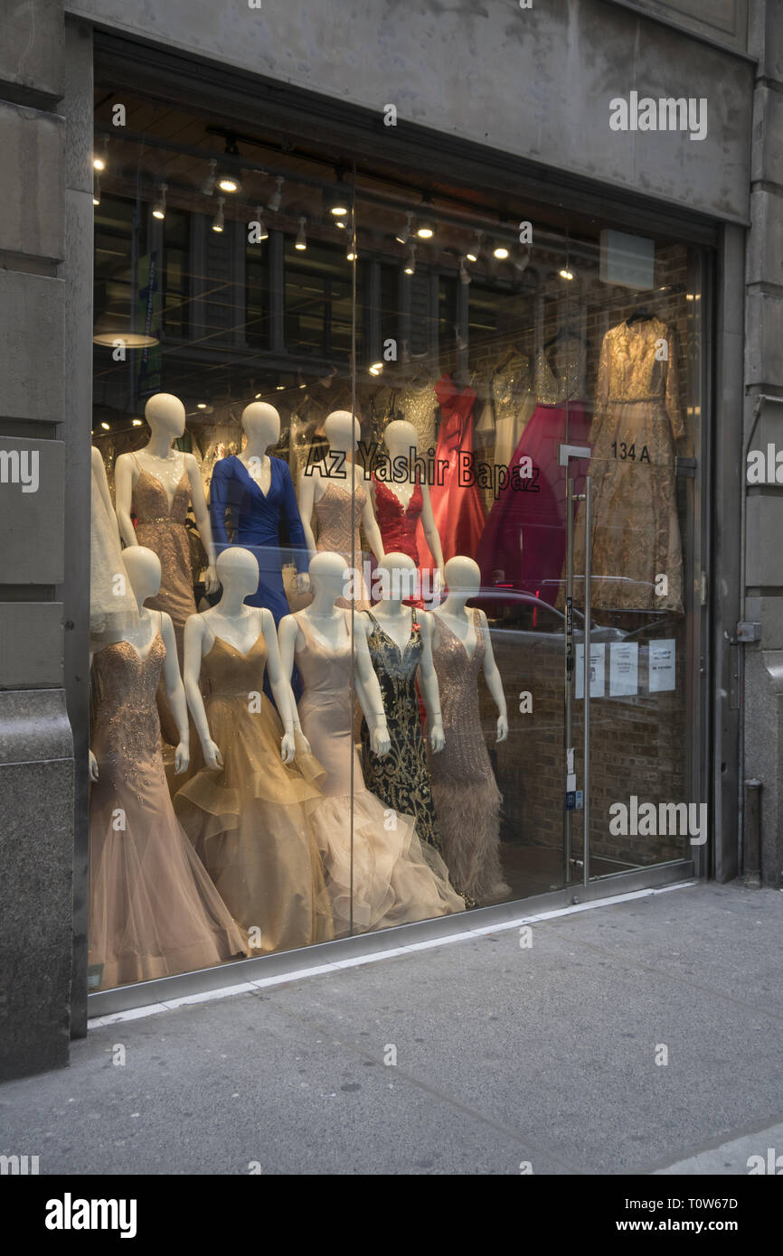 Women's evening dresses on display in a store window. Garment District on the Westside of midtown Manhattan. Stock Photo