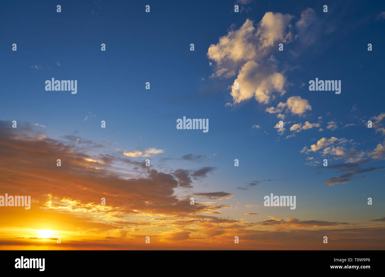 Sunrise or sunset sky with clouds in blue and orange Stock Photo
