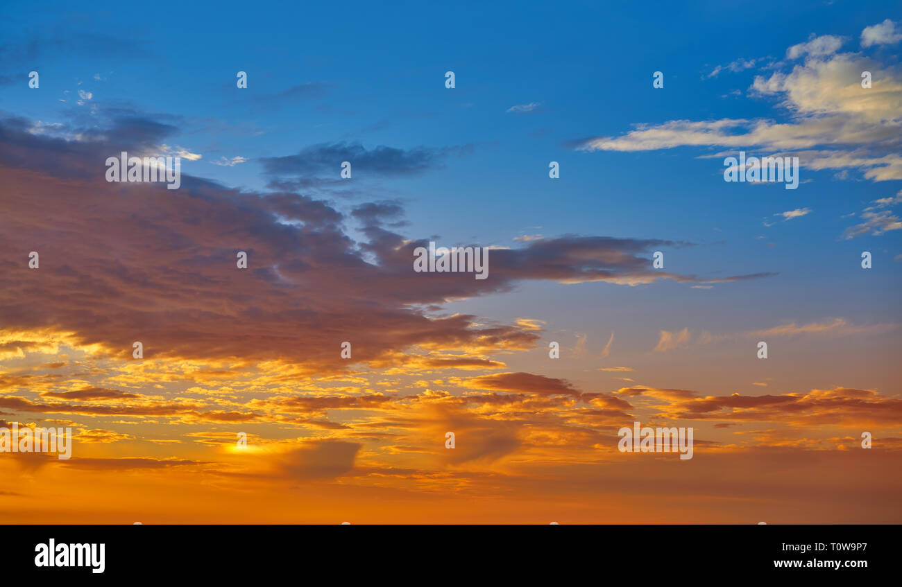 Sunrise or sunset sky with clouds in blue and orange Stock Photo - Alamy