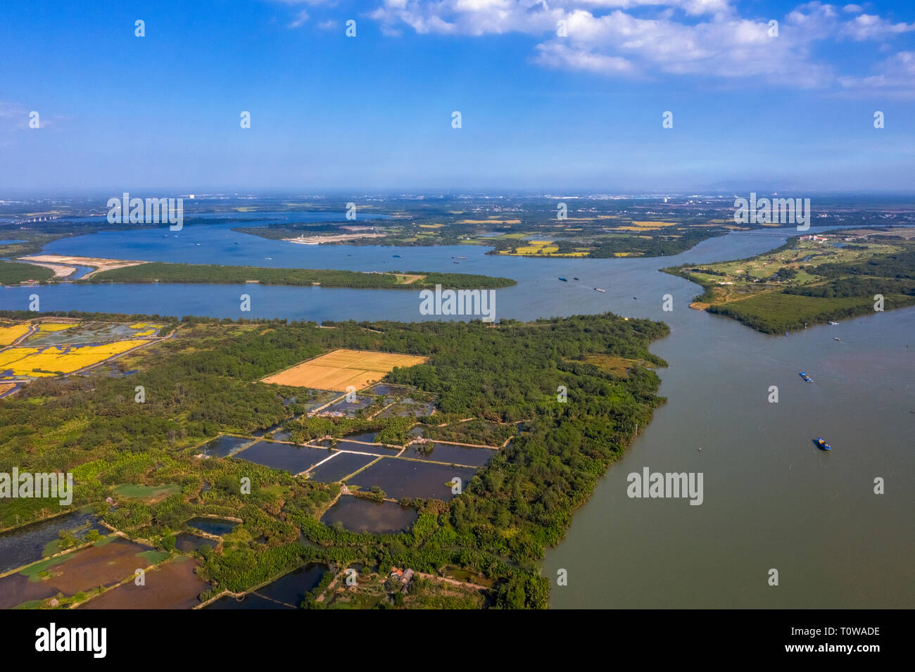 Top view aerial of Xoai Rap river, Ho Chi Minh City with development buildings, transportation, energy power infrastructure. Vietnam Stock Photo