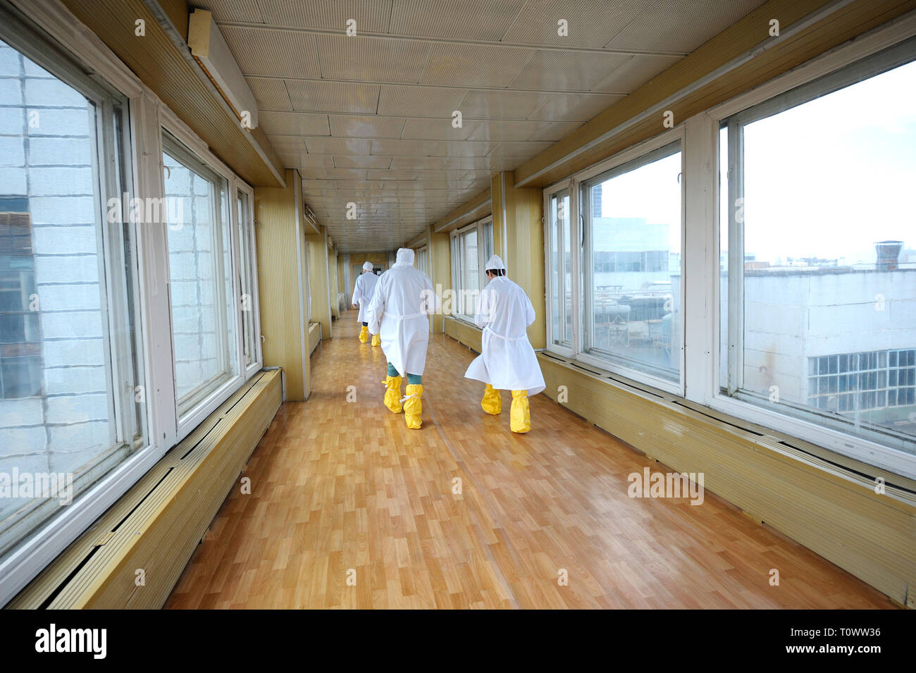 Workers in protective clothes going down the passageway of the