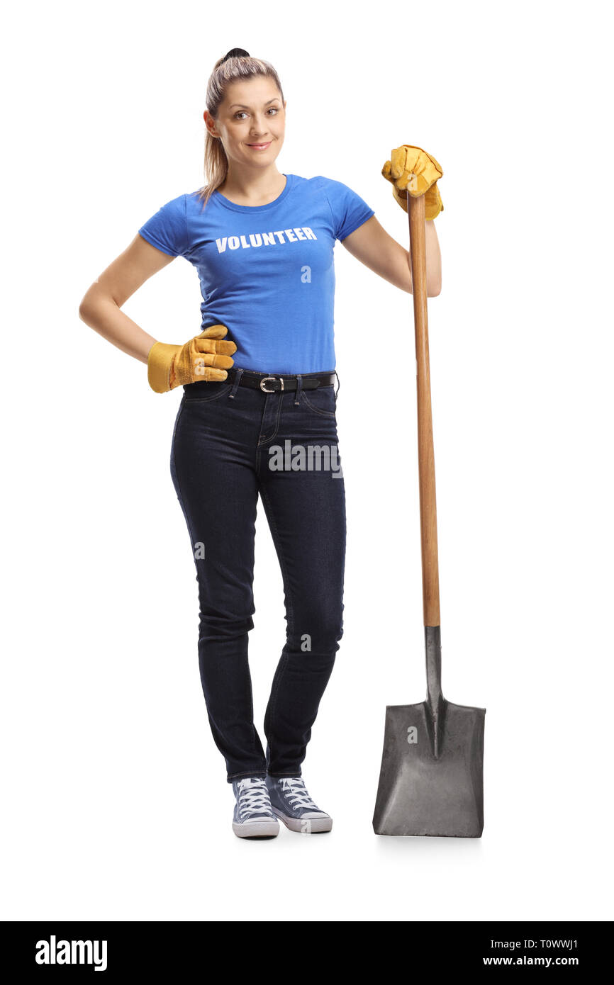 Full length portrait of a woman volunteer standing with a shovel isolated on white background Stock Photo