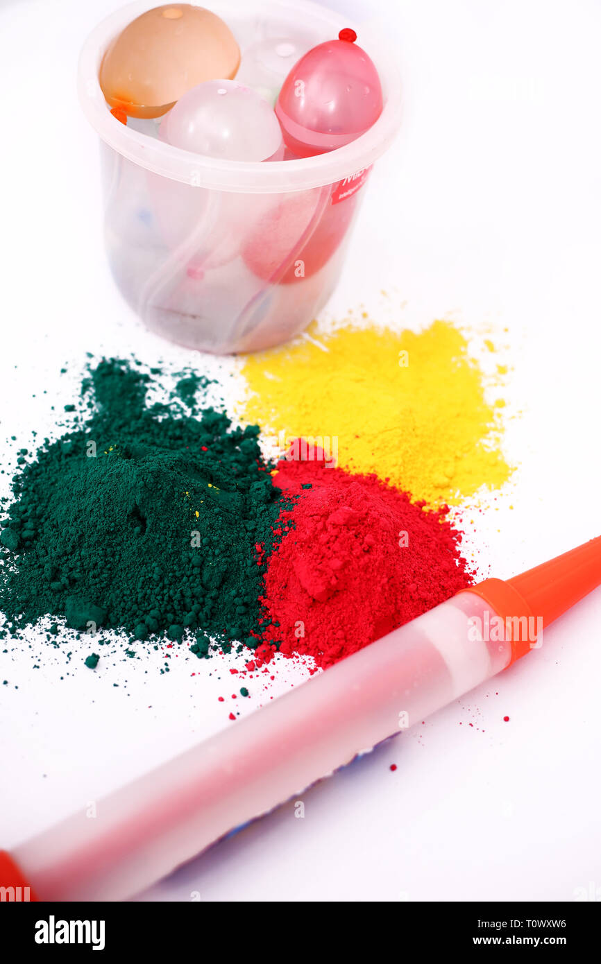 Picture of holi color and pichkari with water balloons in bucket for