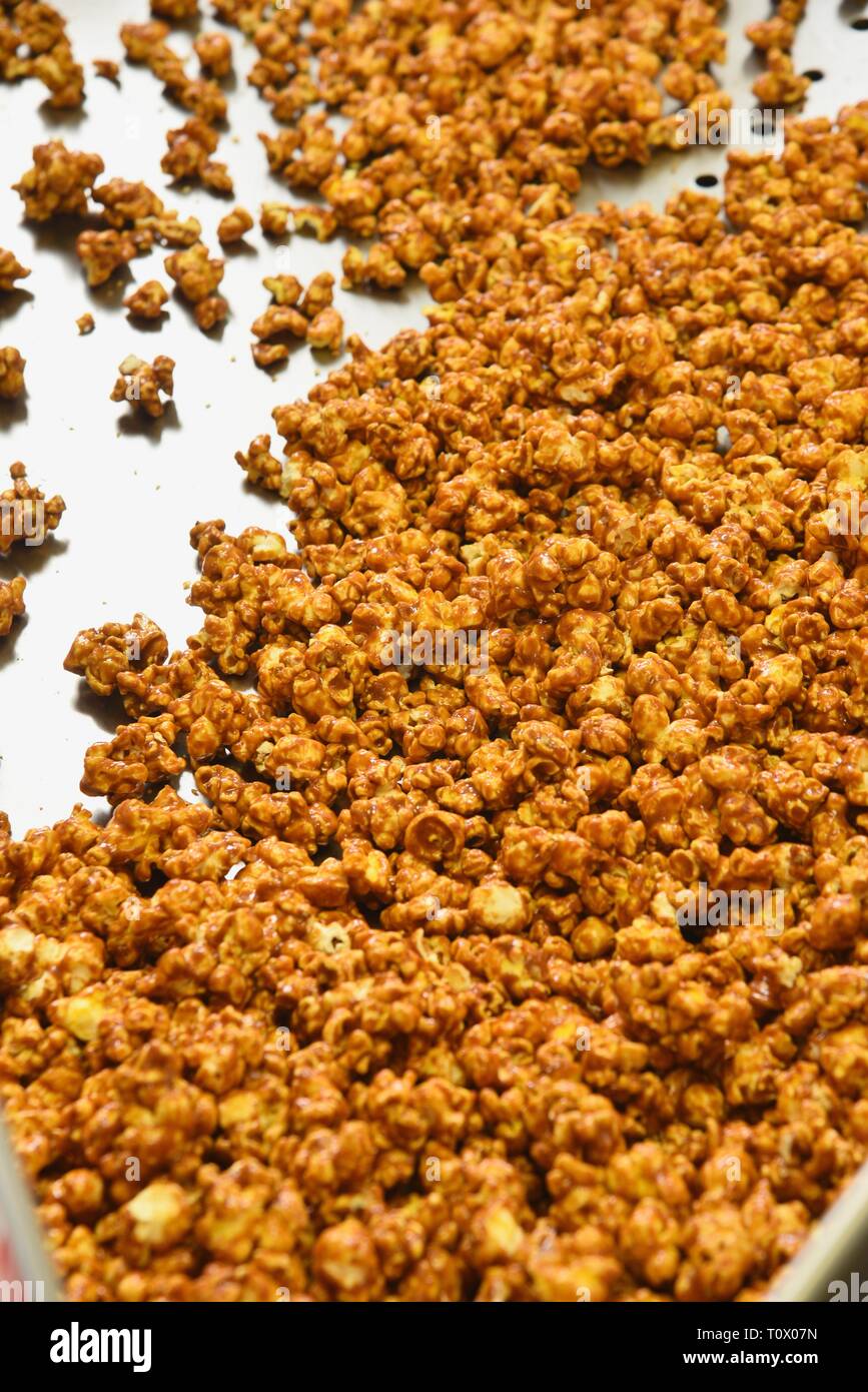 Close up pile of lots of crunchy, crisp delicious popcorn, ready for a snack at a baseball game, circus, movie theater or concession stand. Stock Photo