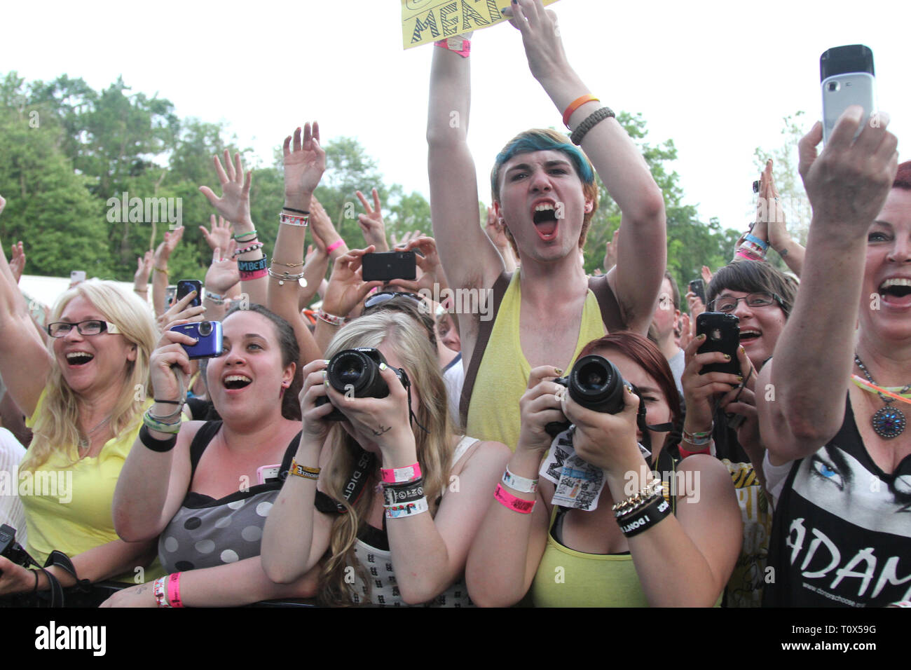 Playing With Fans Fans are shown photographing the performer on stage during a