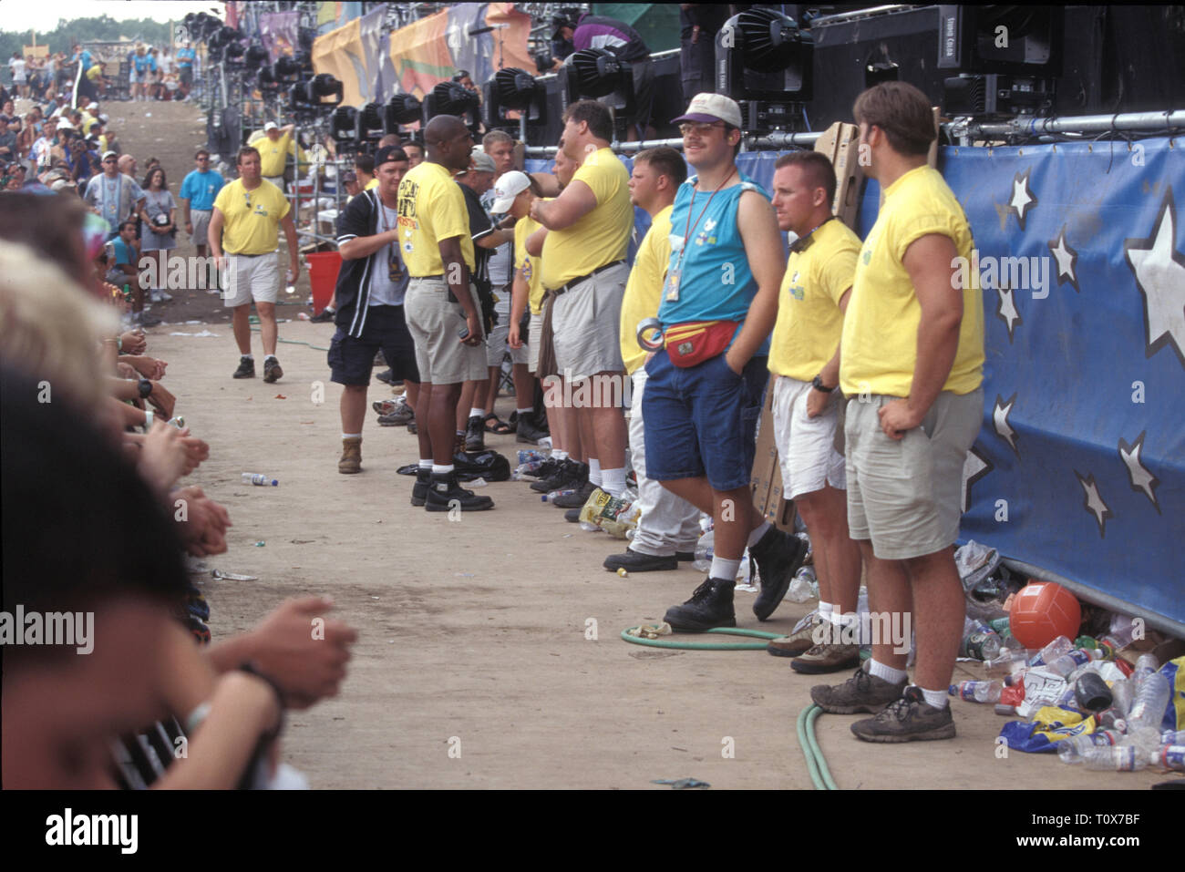 Concert security is shown lined up across one of the main stages during
