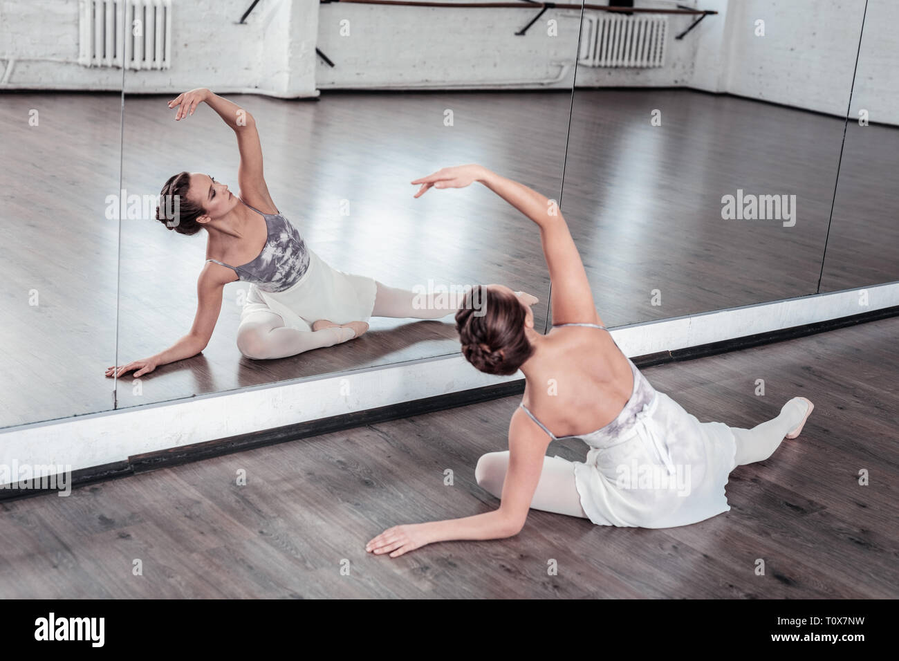 Attractive young woman practicing her dancing movements Stock Photo