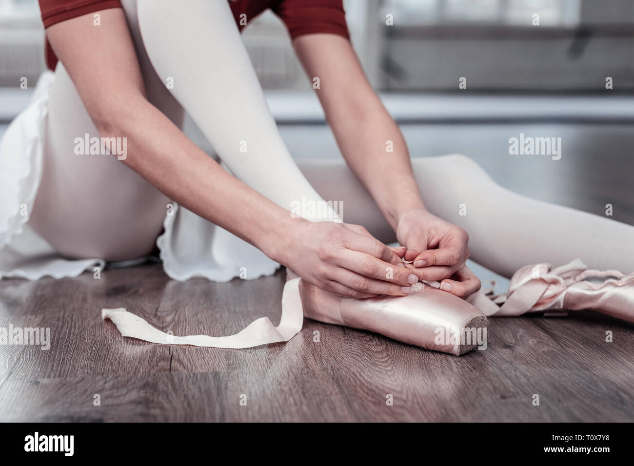 Nice young woman putting on her ballet shoes Stock Photo Alamy