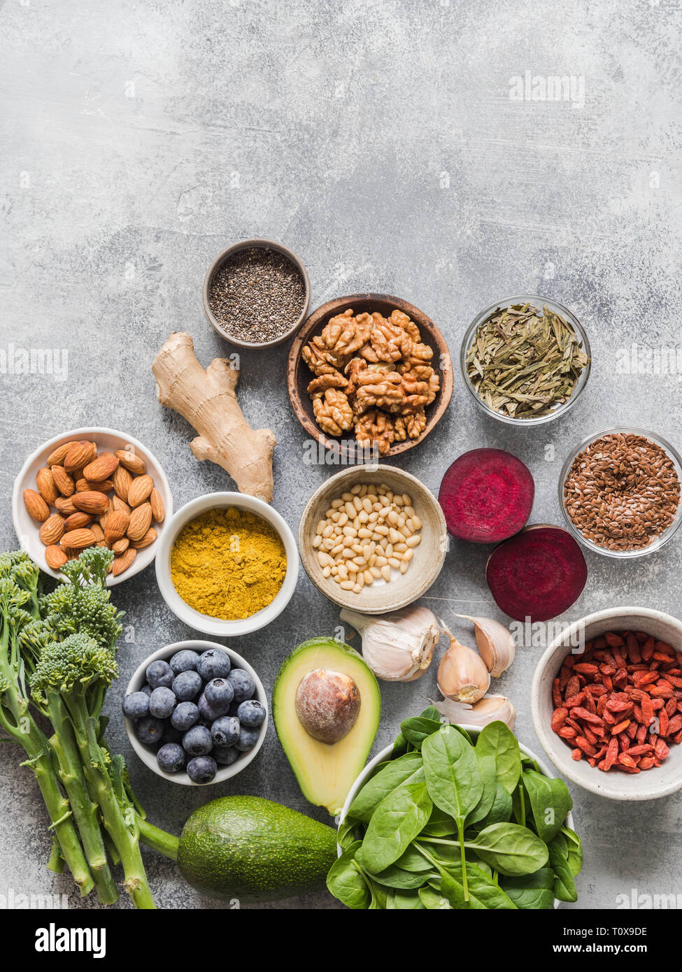 Healthy clean food vegetables, fruits, nuts, superfoods on a gray