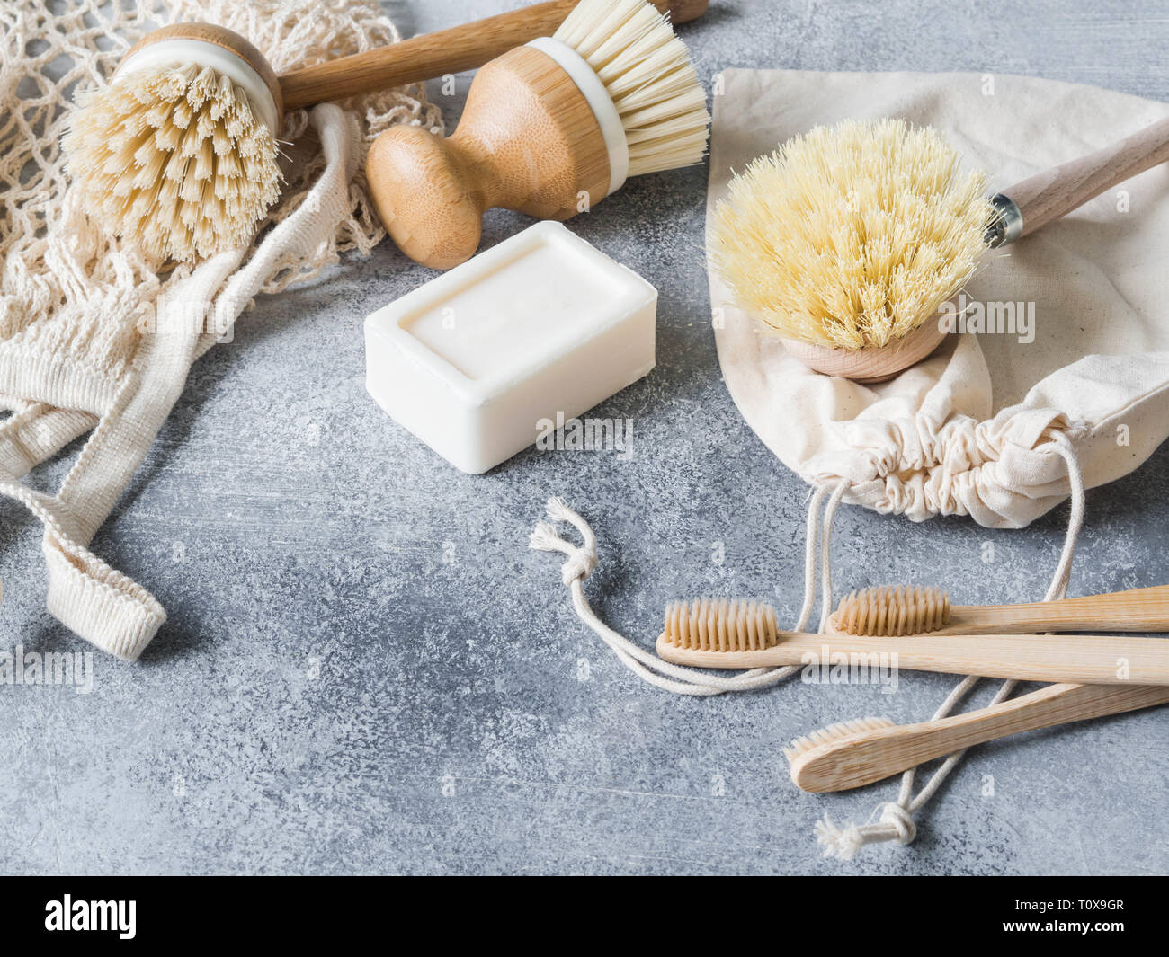 Dish washing brushes, bamboo toothbrushes, reusable bags. Sustainable lifestyle zero waste concept. Clean without waste. No plastic objects. Copy spac Stock Photo